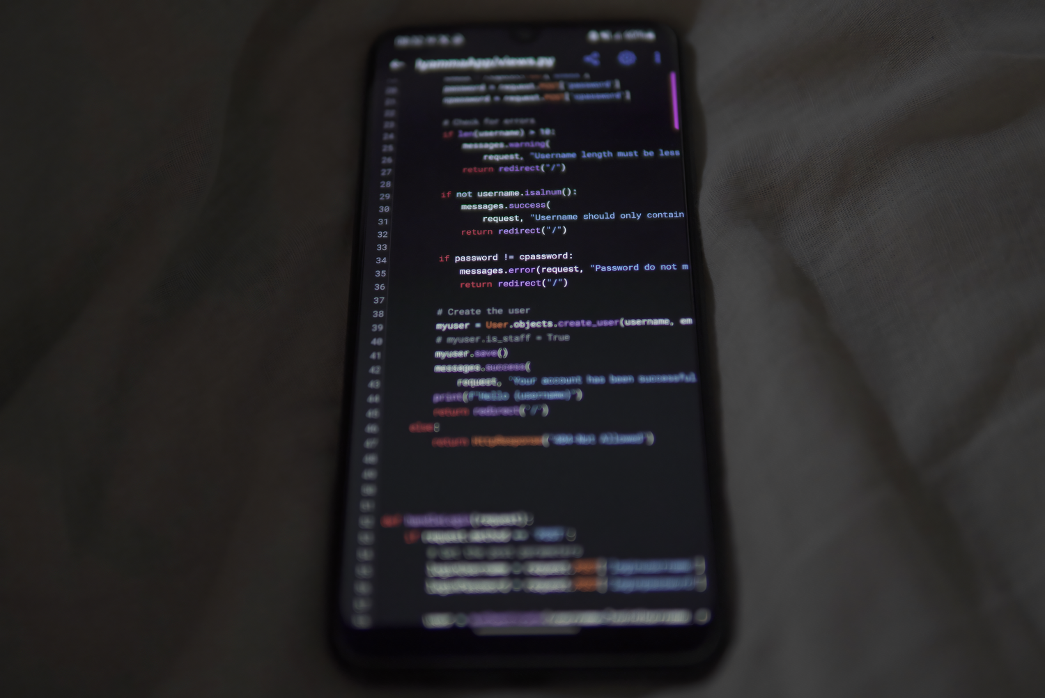 Primer plano de un smartphone mostrando código de programación en Python, representando las herramientas de desarrollo y programación móvil.